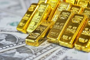 Gold bars against a background of US dollars